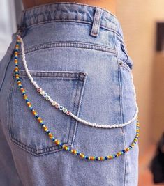 the back of a person's jeans with beads on them