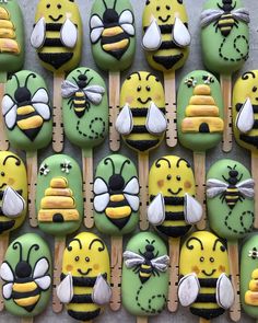 many decorated cookies are arranged in the shape of bee's and honeybees