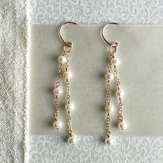 Add a hint of elegance to your bridal look with this timeless pair of dainty pearl earrings. Crafted from 14k rose gold-filled metals, these delicate drop earrings feature two strands of creamy freshwater pearls for a timelessly romantic design. Perfect for the modern bride or any special occasion, these earrings will add a finishing touch to your ensemble. Diy Wedding Earrings Handmade Jewelry, Homemade Jewerly, Diy Earrings Pearl, Dainty Pearl Earrings, Pearl Earrings Handmade, Aesthetic Earrings, Jewelry Set Design, Handmade Jewelry Tutorials, The Modern Bride