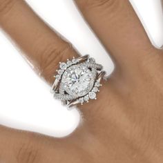 a woman's hand with a diamond ring on top of her finger and an engagement band