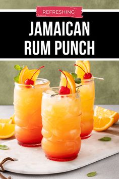 three glasses filled with orange rum punch and garnished with cherries