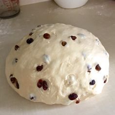 a doughnut sitting on top of a counter covered in raisins