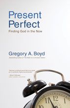 an alarm clock sitting in front of a book cover that reads present perfect finding god in the now