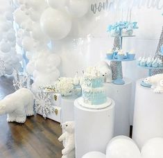 there is a cake and balloons on the floor in this room with white decors