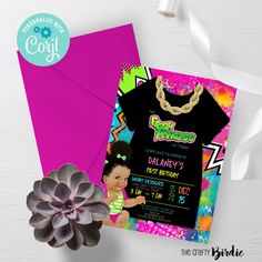 a pink envelope with a black t - shirt and gold necklace on it next to a flower