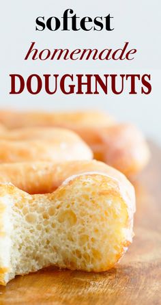 homemade doughnuts on a wooden cutting board with the words softest homemade doughnuts