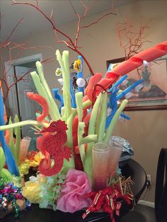 an arrangement of fake corals and seaweed on a table