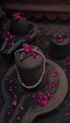 an old hat with pink flowers on it sitting on a plate next to other hats