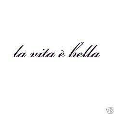 the word la vita e bella written in black ink