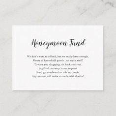 a white business card with the words honeymoon fund written in cursive writing on it