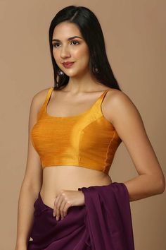 Product Features: Blouse Color: Mustard Blouse Fabric: Silk Work: Solid Sleeve Length: Sleeveless In Closer: Back Open Padded / Non Padded : Padded Wash Care : Dry Clean Occasion : Festivewear, Partywear, Wedding Guest Product Type : Blouse Disclaimer: There will be slight difference in digital to actual image Gold Unstitched Blouse For Summer, Fitted Yellow Padded Top, Gold Blouse Piece For Summer, Gold Summer Blouse Piece, Sleeveless Gold Camisole For Summer, Gold Sleeveless Summer Camisole, Gold Sleeveless Camisole For Summer, Unstitched Sleeveless Blouse Piece For Summer, Sleeveless Unstitched Summer Blouse Piece