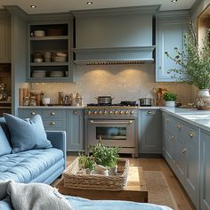 a blue couch sitting in a kitchen next to a stove top oven