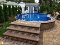 an above ground swimming pool with steps leading up to it and a patio area in the background