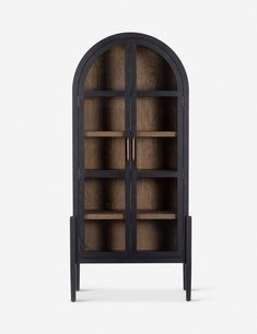 a black bookcase with glass doors on the front and bottom shelves, against a white background