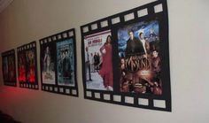 the movie posters are hanging on the wall