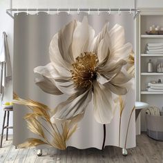 a shower curtain with a large white flower on the front and gold petals on the back