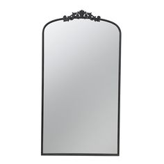 a large mirror with an ornate design on the top and bottom frame, in black