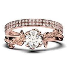 a rose gold engagement ring with diamonds on the band and an intricate vine motif design