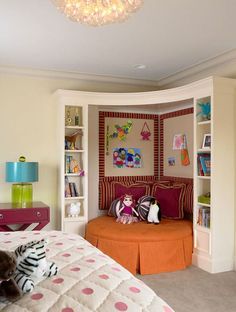 a child's bedroom decorated in pink, orange and white with bookshelves