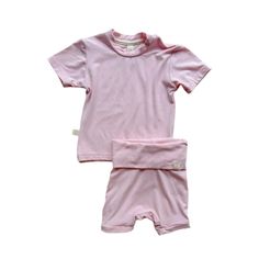 Upgrade your baby's wardrobe with our premium bamboo outfits, featuring elastic-free shorties with a fold over-waistband and knee length leg cuffs to  provide maximum comfort around baby's belly and thighs, paired perfectly with our bamboo relaxed fit t-shirt. This set is made from high-quality bamboo that is incredibly soft with the perfect amount of stretch, offering exceptional comfort, breathability, and eco-friendliness.   Product Details:     95% Bamboo Viscose, 5% Spandex  Relaxed Fit Tee Pink Luxury, Baby Belly, Unique Baby Gifts, Knee Length Shorts, Neutral Design, Tee Set, Leg Cuffs, Unique Baby, Fold Over