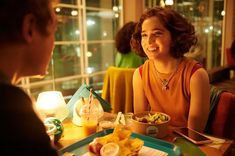 a woman sitting at a table with food in front of her