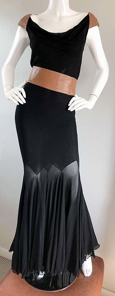 For Sale on 1stDibs - Extremely rare 1992 GIANNI VERSACE COUTURE Musuem Worthy black silk chiffon and leather full length evening dress! Features a super flattering base full Elegant Floor-length Ballroom Evening Dress, Elegant Fitted Evening Dress For Ballroom, Elegant Black Ballroom Dresses, Black Luxury Silk Evening Dress, Versace Vintage Couture, Vintage Versace Runway, Black Bias Cut Floor-length Evening Dress, Vintage Gianni Versace Dress, Vintage Versace 2003 Ready To Wear Collection