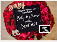 a bouquet of roses with a baby announcement on it