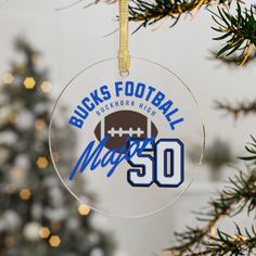 a football ornament hanging from a christmas tree with the number 50 on it