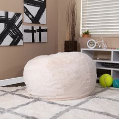 a white bean bag sitting on top of a rug