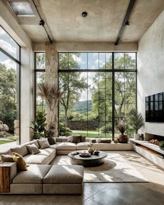 a modern living room with large windows and stone flooring is pictured in this image