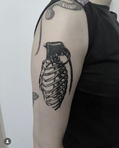 a woman's arm with a skeleton tattoo on it and an owl in the ribcage