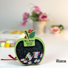 an apple shaped magnet with the name mrs potter written on it's front and back