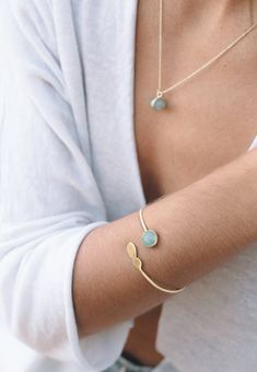 Our 18k Gold plated delicate bracelet with a nice natural gem is the perfect for elegant ocasions.This unique bracelet design consists in a real gemstone of 12 mm diameter in round shape on one edge and a delicate plain gold finishing on the other.Available in different gems: rose quartz, labradorite, jade and aqua chalcedony.This piece is fully adjustable, able to wear it on the up side of the arm or on the wirst.This delicate bracelet is the a perfect present for all those who loves the minima Adjustable Gold Gemstone Bracelet Gift, Adjustable Gemstone Gold Bracelet For Gifts, Adjustable Gemstone Gold Bracelet As A Gift, Gold Plated Bracelets With Natural Stones For Gift, Minimalist Gold Plated Cuff Bracelet Gift, Gold Gemstone Bangle Bracelet Gift, Unique Bracelet Design, Gold Arm Band, 18k Gold Bracelet