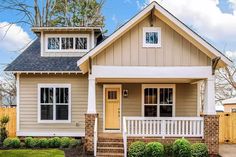 a small house with a yellow front door