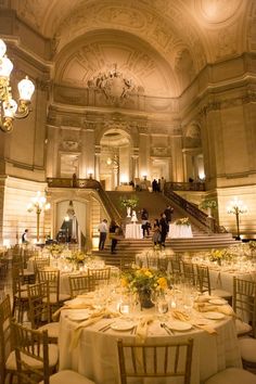 an elegantly decorated ballroom with chandeliers and tables