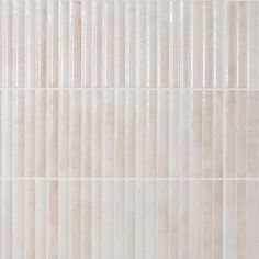 a white tile wall with vertical lines on it