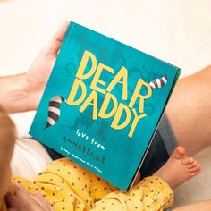 a person reading a book to a baby