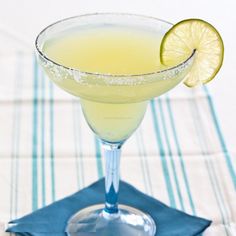 a margarita cocktail with a lime slice on the rim