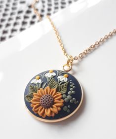 a necklace with a flower painted on it