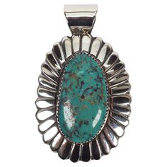 An impressive 18 x 33mm natural turquoise cabochon is featured on this thick gauge scalloped sterling silver pendant crafted by known Navajo silversmith, Arnold Blackgoat. Measuring two inches in length plus the bail and 1.5 inches in width, this artisan crafted Navajo sterling pendant beautifully displays it's earthy oval Turquoise stone that is bezel set and framed in scalloped sterling silver. The piece is signed by its maker A. Blackgoat, who is a 4th generation artisan from the remarkable Blackgoat family of talented silversmiths. Gift boxed. Southwestern Oval Jewelry With Polished Finish, Southwestern Style Oval Jewelry With Polished Finish, Large Western Style Pendant Jewelry, Southwestern Style Oval Jewelry With Large Pendant, Sterling Pendant, Artisan Craft, Natural Turquoise, Turquoise Sterling Silver, Turquoise Stone