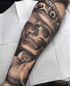 a man with a skull tattoo on his arm