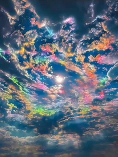 the sky is filled with colorful clouds as the sun shines brightly in the distance