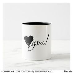 a black and white coffee mug with the word you on it