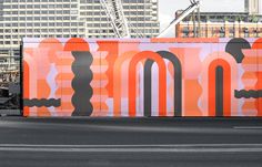 an orange and black advertisement on the side of a building