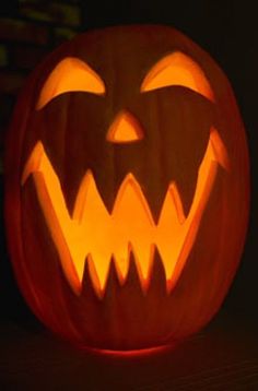 a carved pumpkin with glowing eyes and mouth