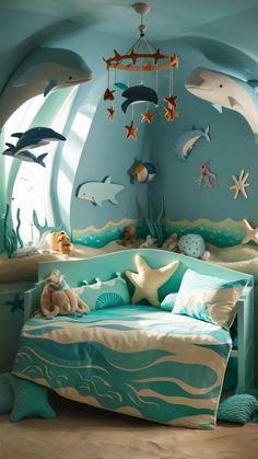 a child's bedroom decorated in blue and green with sea animals on the walls