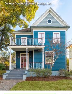 a blue house with white trim and balconies on the second story is shown