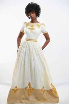 Step into the realm of opulence with our Golden Elegance Embroidered Dress, inspired by the timeless beauty of Habesha Kemis, the iconic Ethiopian cultural cloth. Crafted with meticulous attention to detail, this dress features intricate golden embroidery that exudes regal charm and sophistication. The rich cultural heritage of Ethiopia is woven into every stitch, making this dress a true masterpiece of Ethiopian craftsmanship. Indulge in the luxurious feel of the fabric as it drapes elegantly a Resham Embroidered Dresses For Eid, Traditional Long Embroidered Dress For Festive Occasions, Traditional Embroidered Long Dresses, Traditional Dresses With Short Sleeves For Ceremonies, Traditional Floor-length Dresses With Embroidered Border, Intricate Embroidery Maxi Dress For Traditional Ceremonies, Traditional Short Sleeve Dresses For Ceremonies, Ceremonial Dresses With Resham Embroidery For Eid, Traditional Long Dress With Resham Embroidery