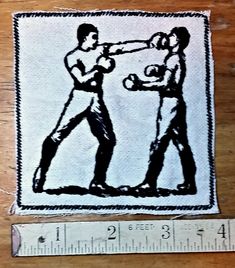 a drawing of two men hitting each other with boxing gloves on top of a wooden table