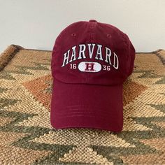 a harvard hat sitting on top of a rug